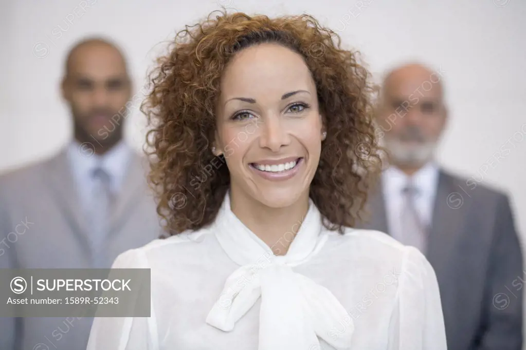 African businesswoman in front of coworkers