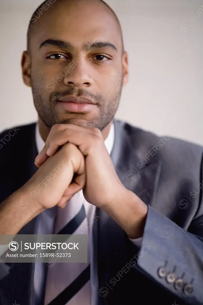 African businessman resting chin on hands
