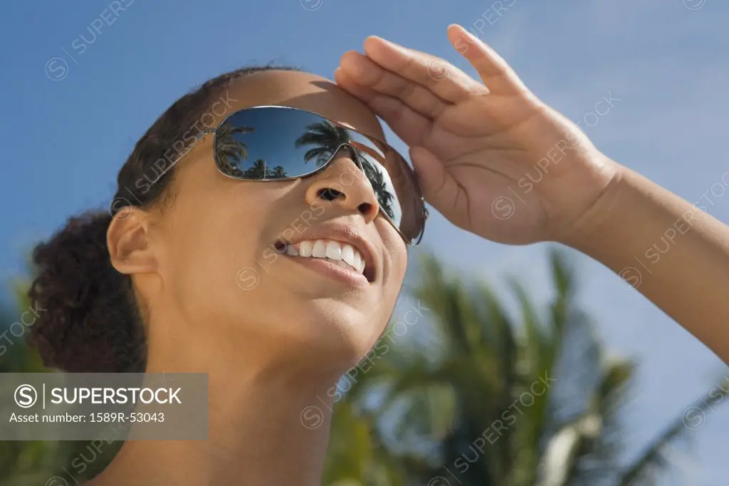 African woman wearing mirrored sunglasses