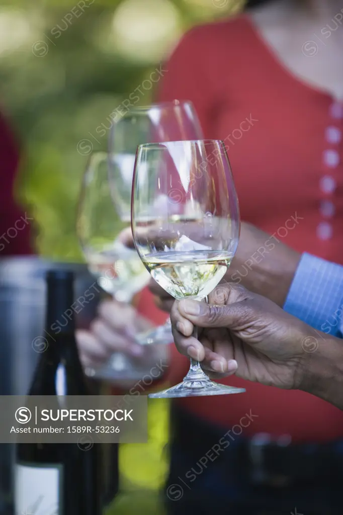 Close of African woman holding wine glass