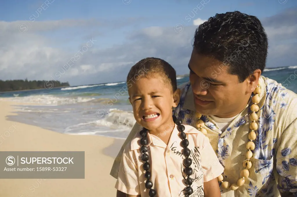 Pacific Islander father and son at beach