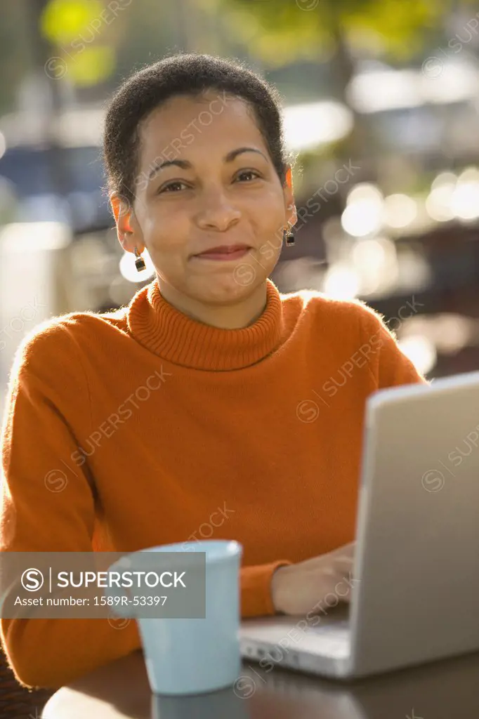 African woman typing on laptop