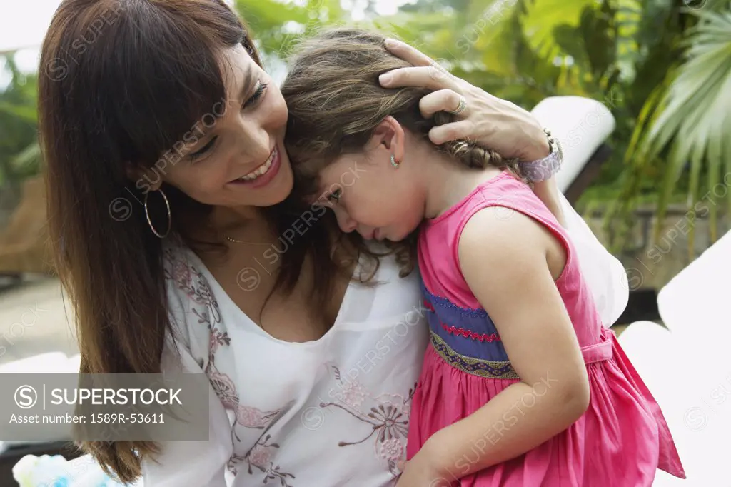 Hispanic mother hugging sad daughter