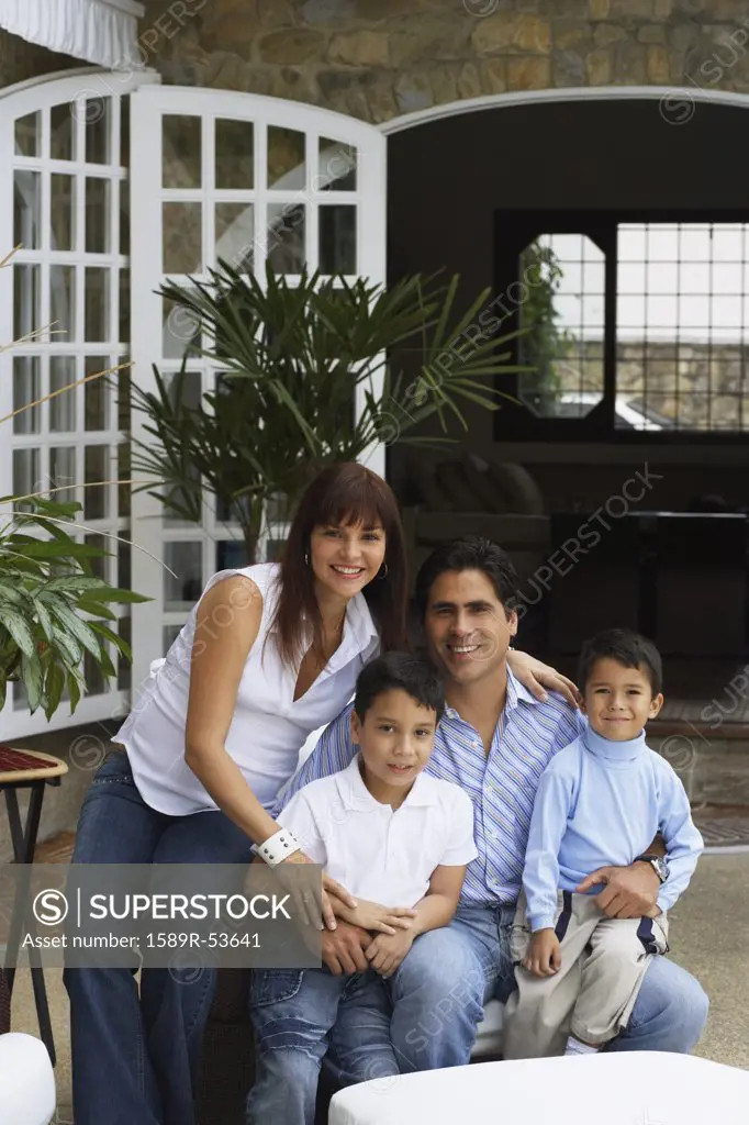 Hispanic family sitting on patio