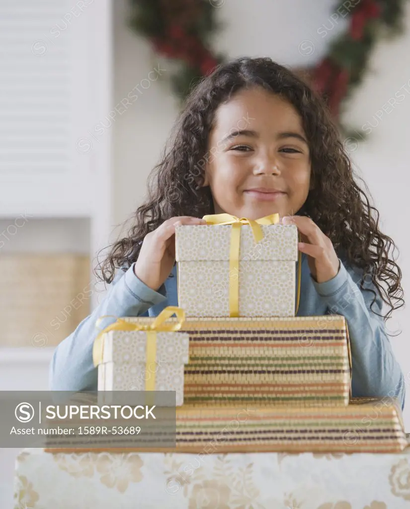 African girl behind stack of gifts