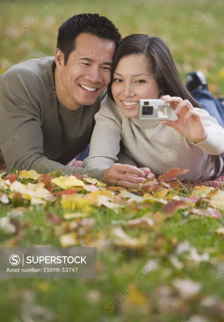 Asian couple taking own photograph