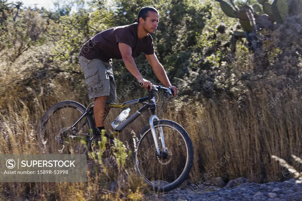 Hispanic man riding mountain bike