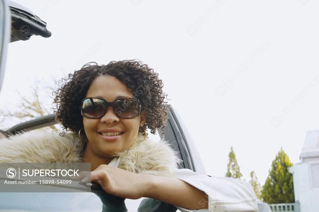 African woman in convertible car