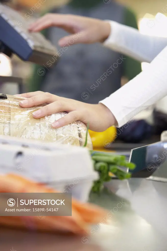 Cashier ringing up groceries