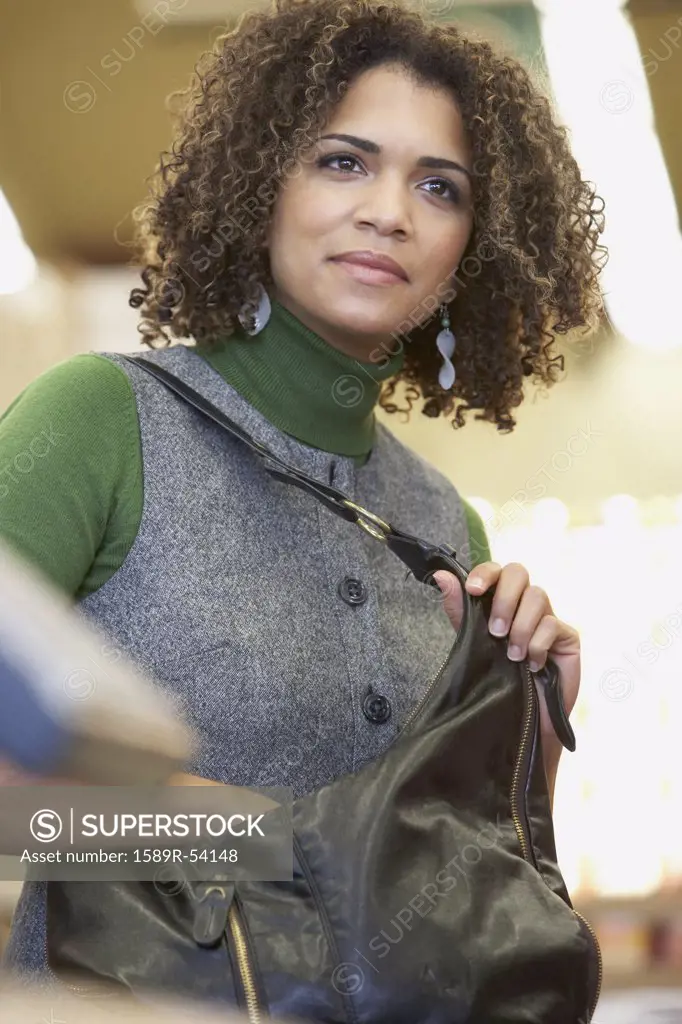 African woman reaching in purse