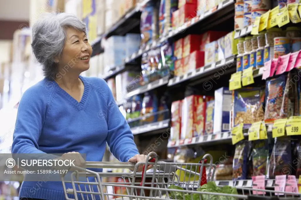 Senior Asian woman shopping in grocery store