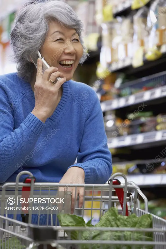 Senior Asian woman talking on cell phone