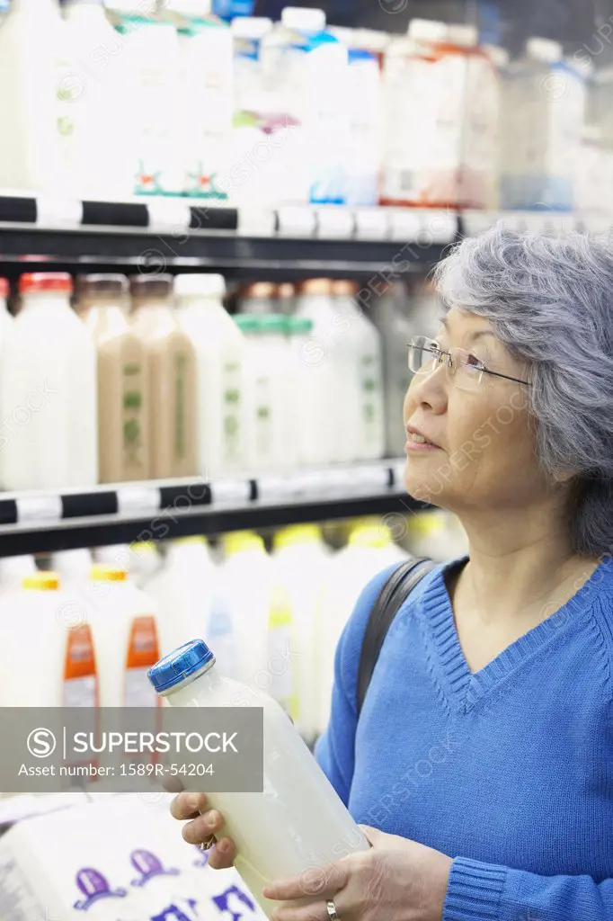 Senior Asian woman shopping in grocery store