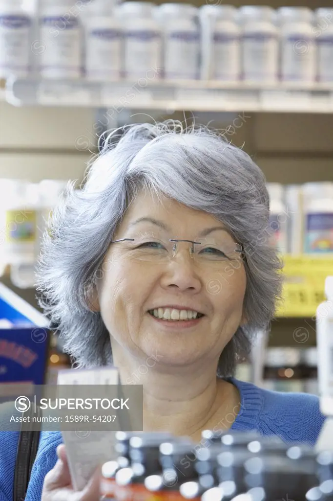 Senior Asian woman shopping for vitamins