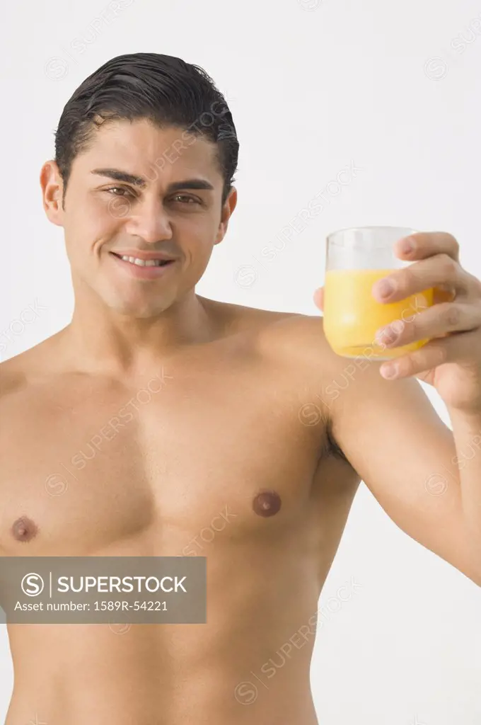 Bare-chested Hispanic man holding orange juice