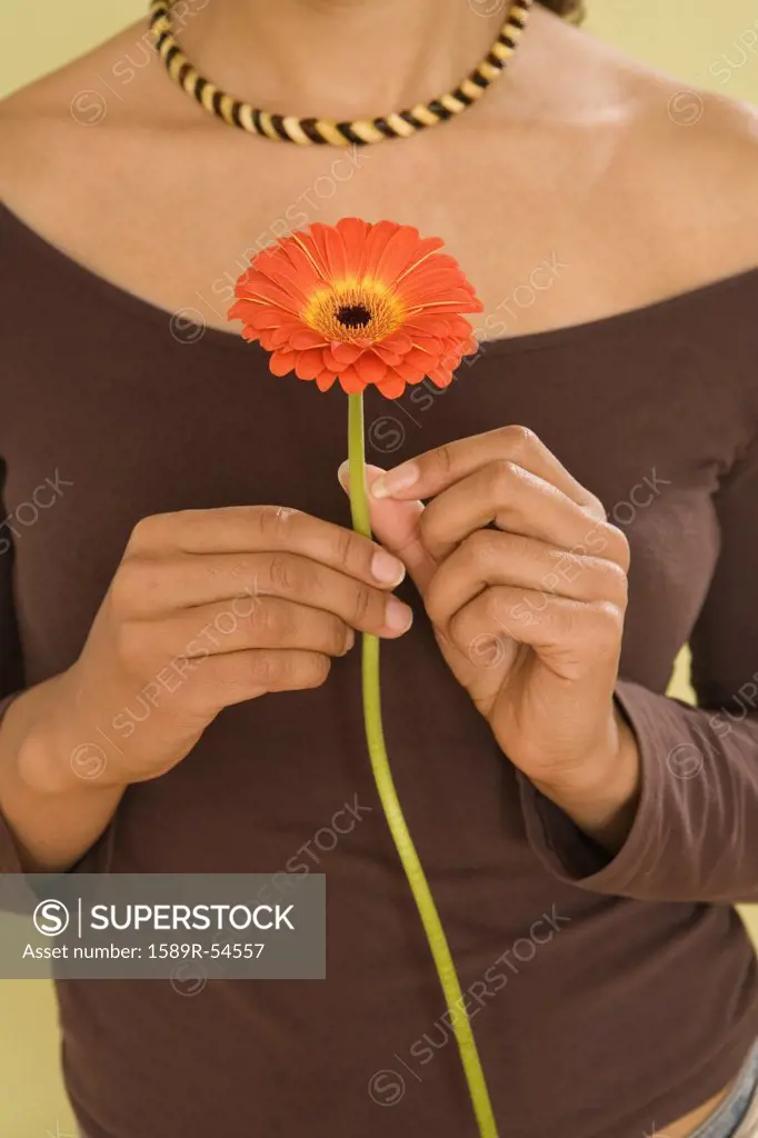 African woman holding flower