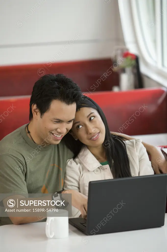 Asian couple using laptop