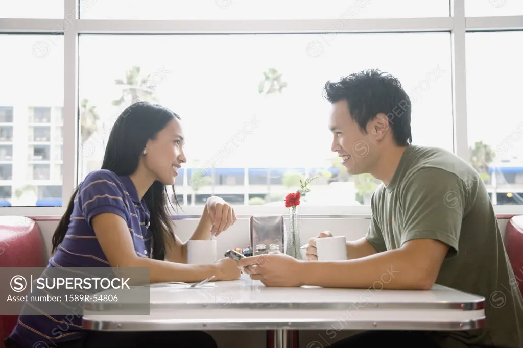 Asian couple smiling at each other