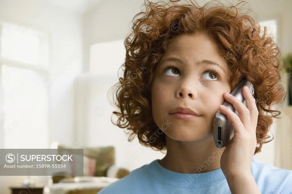 Mixed Race boy talking on cell phone
