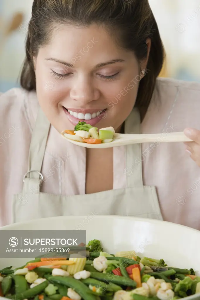 Hispanic woman smelling food