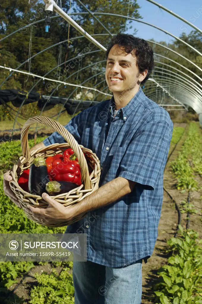 Man holding basket of organic produce