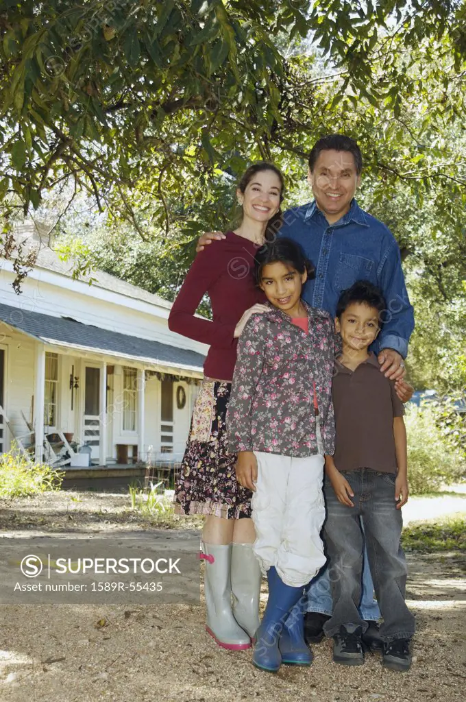 Multi-ethnic family in front of house