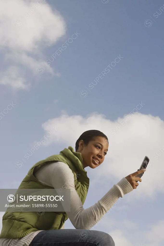 African woman looking at cell phone