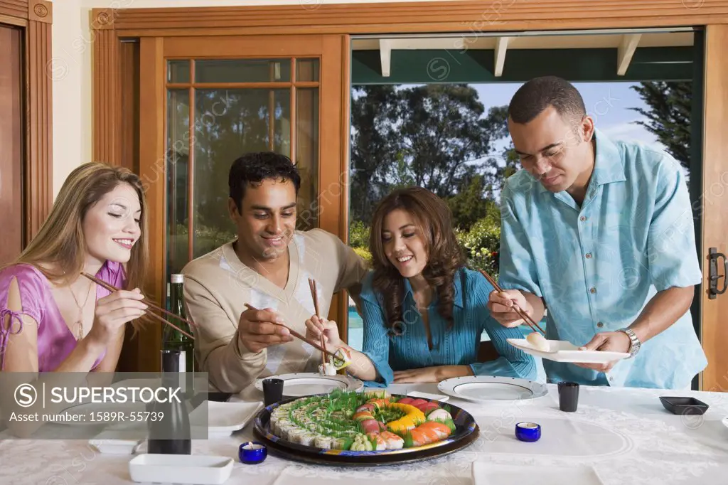 Multi-ethnic couples eating sushi