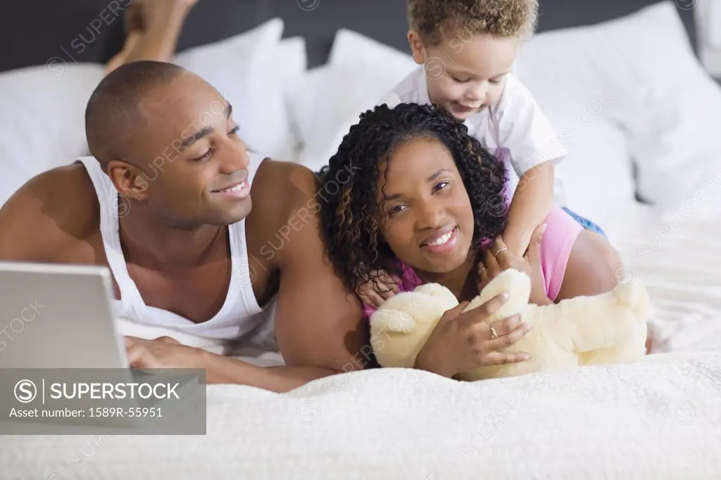 African family laying on bed