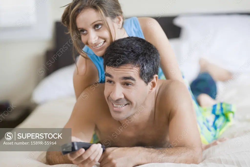 Hispanic couple watching television