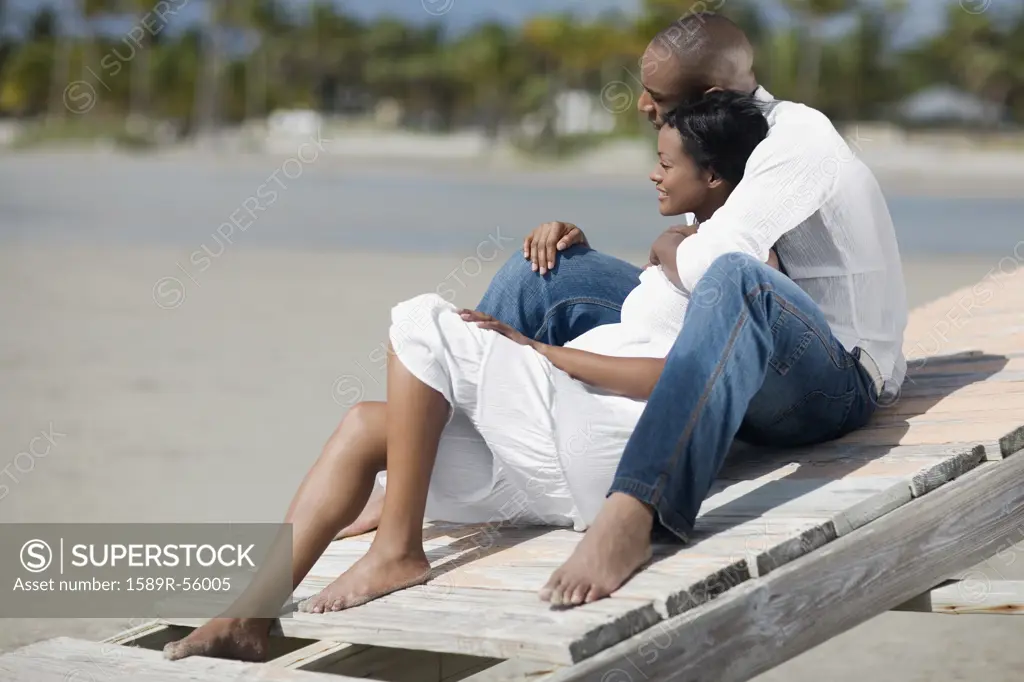 Multi-ethnic couple hugging at beach