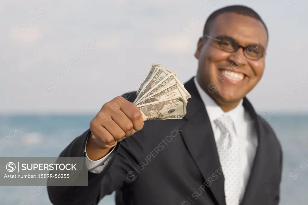 African businessman holding money