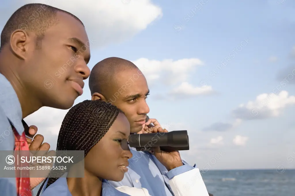 African businesspeople looking through binoculars