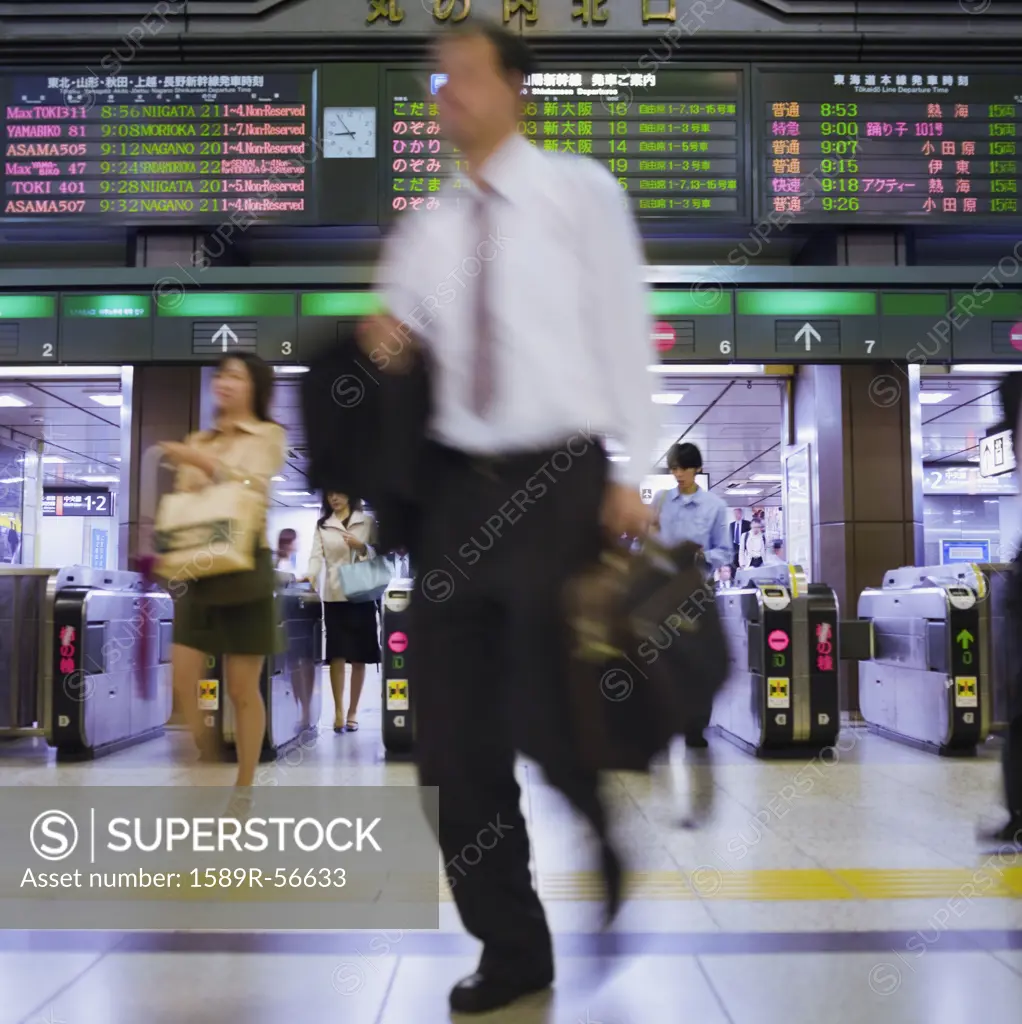 Blurred motion shot of Asian businessman in subway
