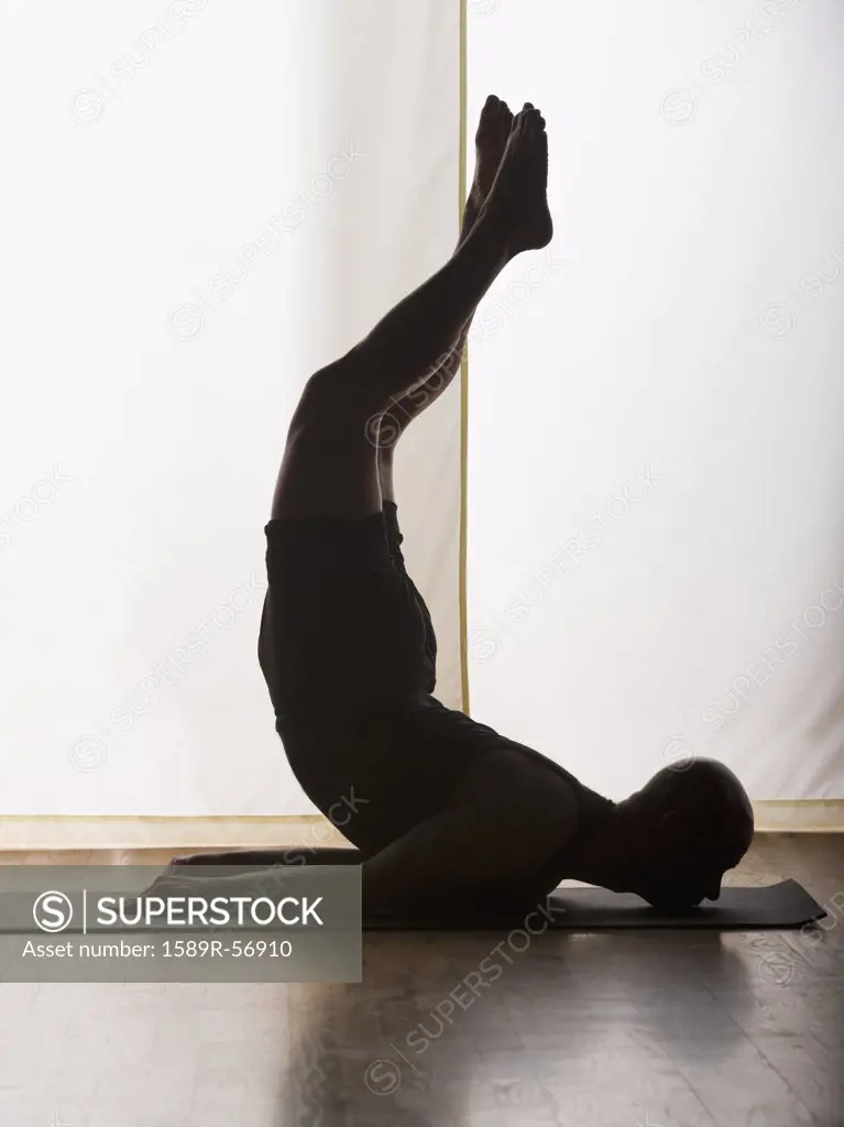 Hispanic man practicing yoga