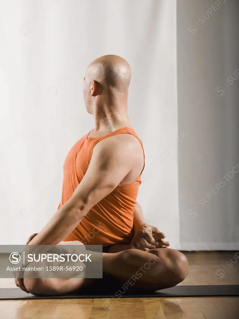 Hispanic man practicing yoga