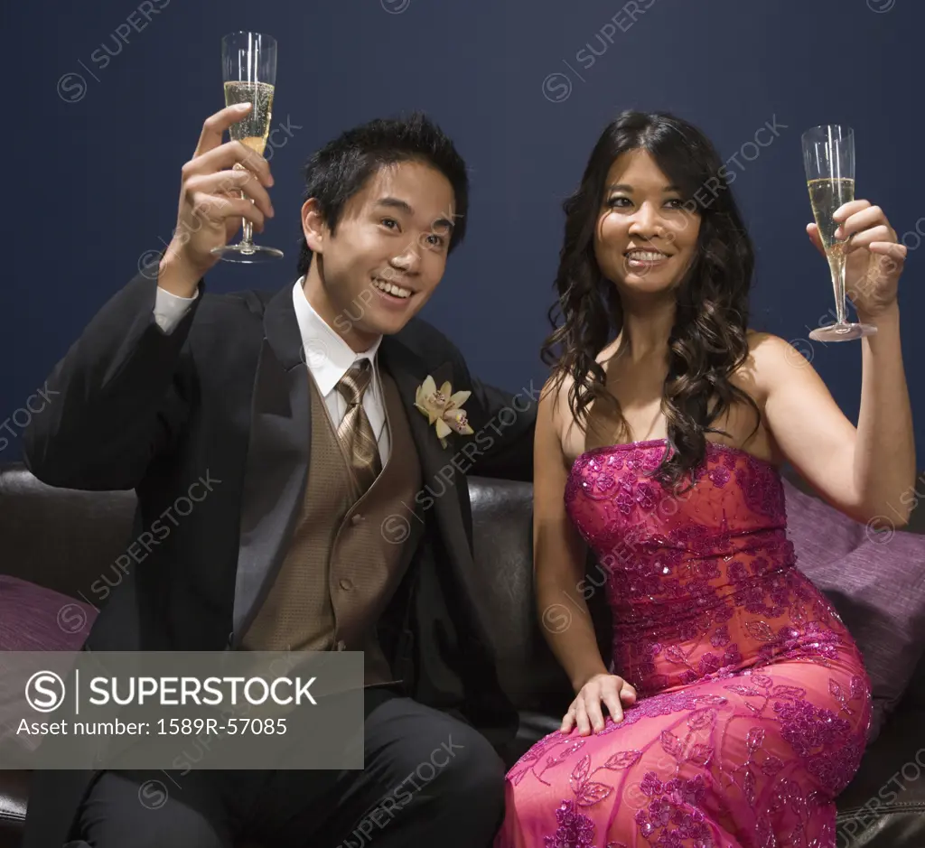 Asian couple toasting with champagne