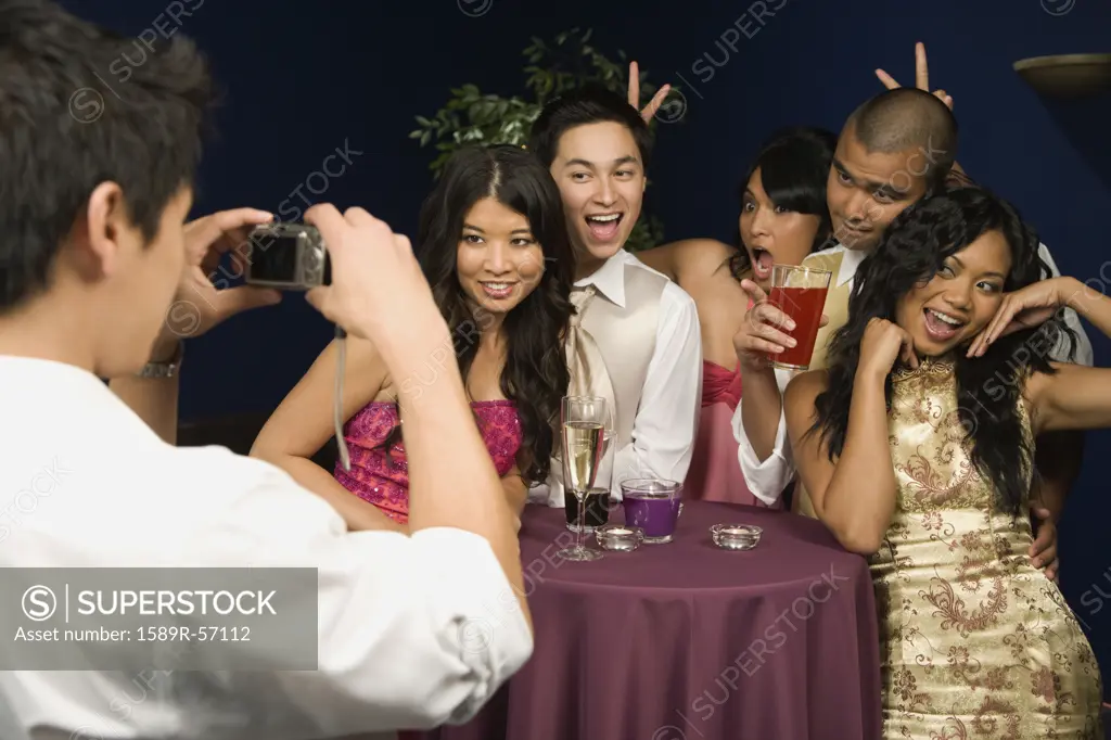 Multi-ethnic couples having photograph taken