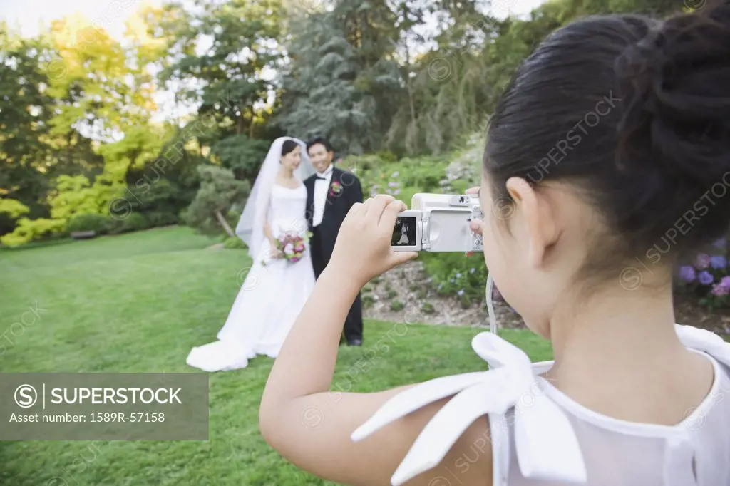 Asian newlyweds having photograph taken