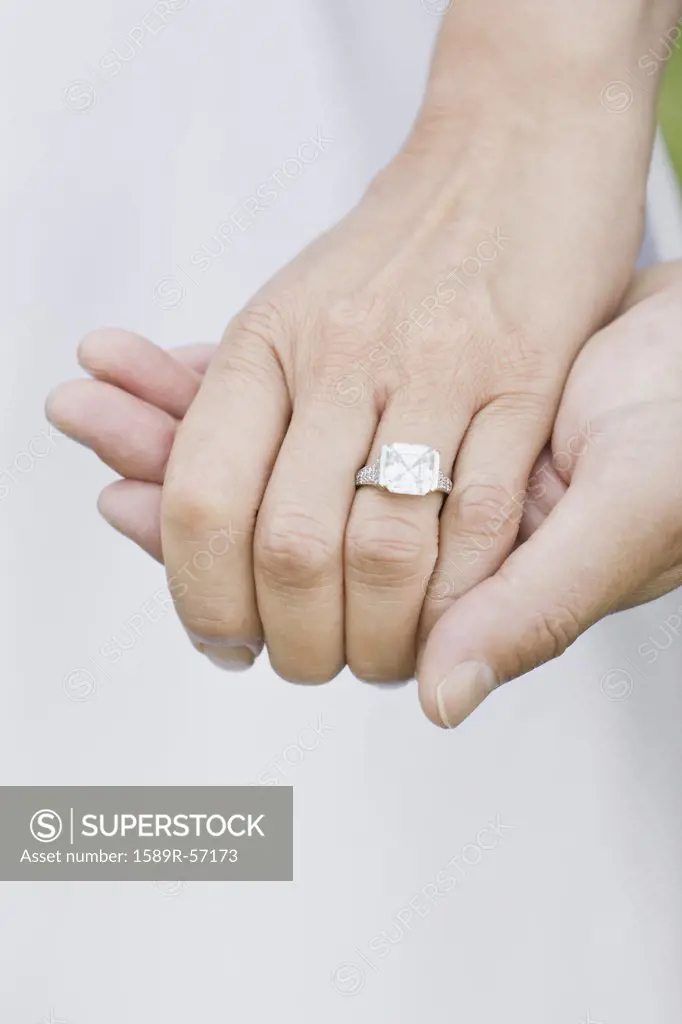 Close up of Asian womans wedding ring