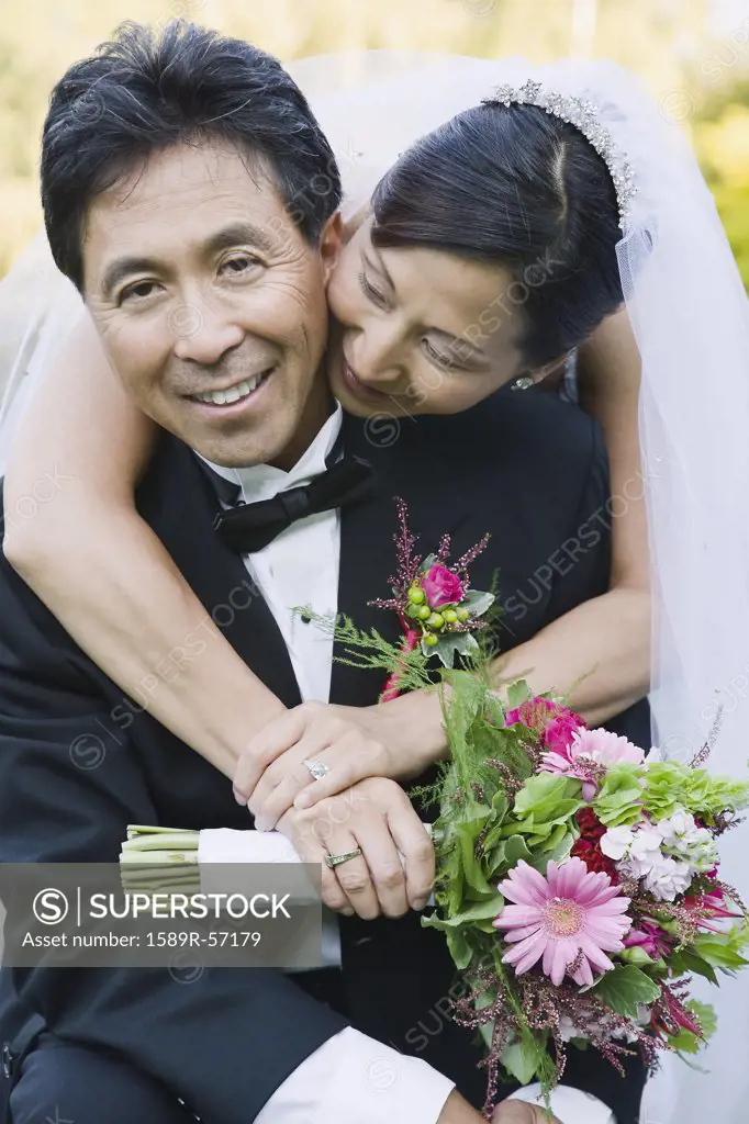Asian newlyweds hugging