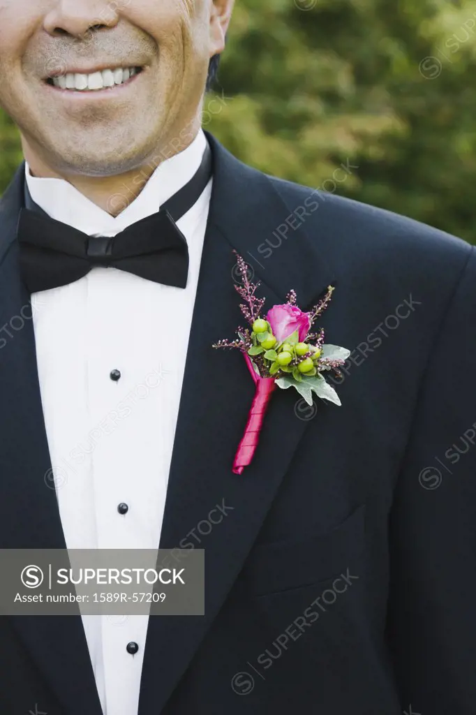 Asian man with boutonniere on lapel