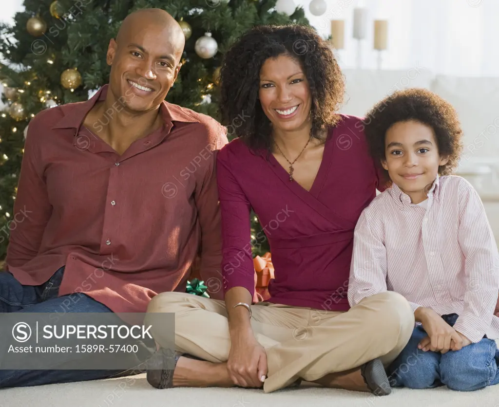 African family in front of Christmas tree