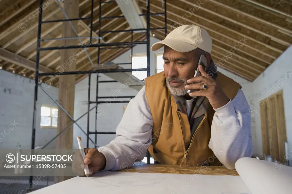 Hispanic architect talking on cell phone