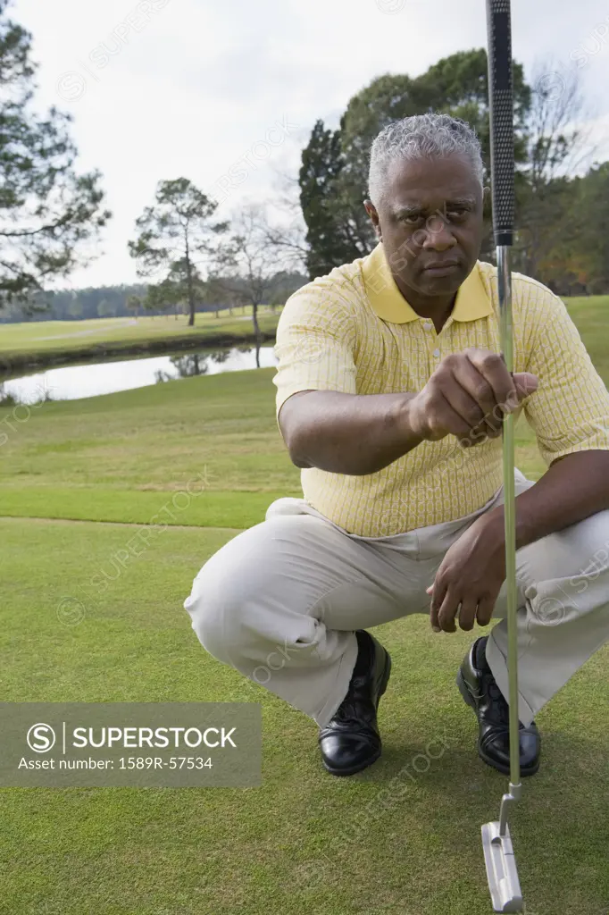 African man playing golf