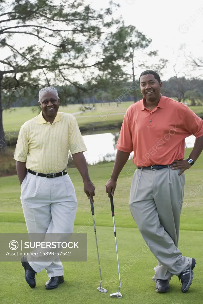African father and adult son on golf course