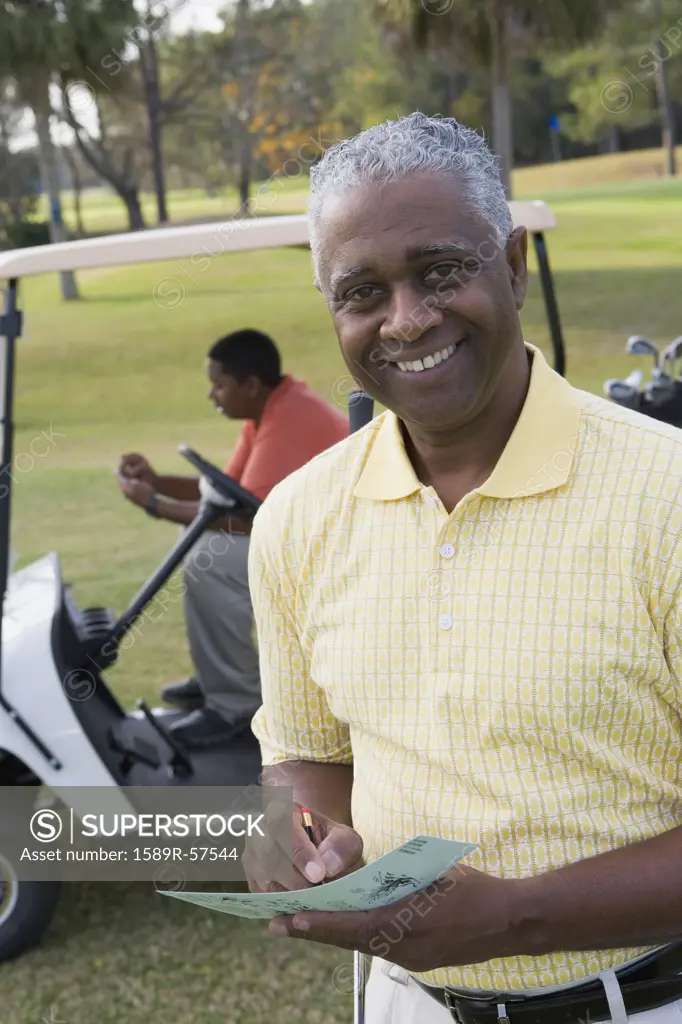 African father and adult son on golf course