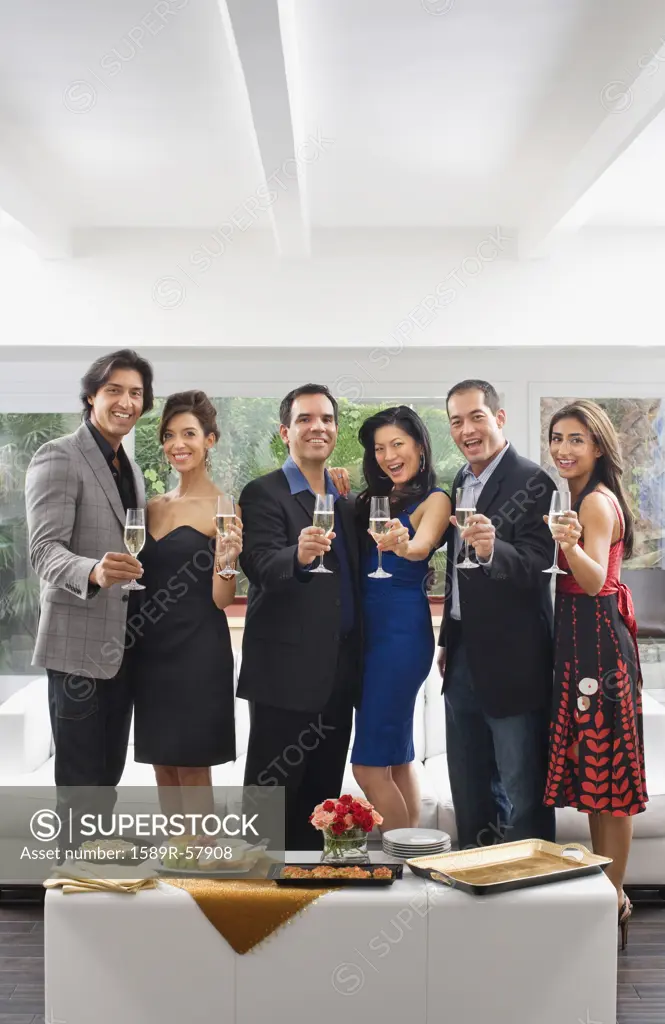 Multi-ethnic couples toasting with champagne