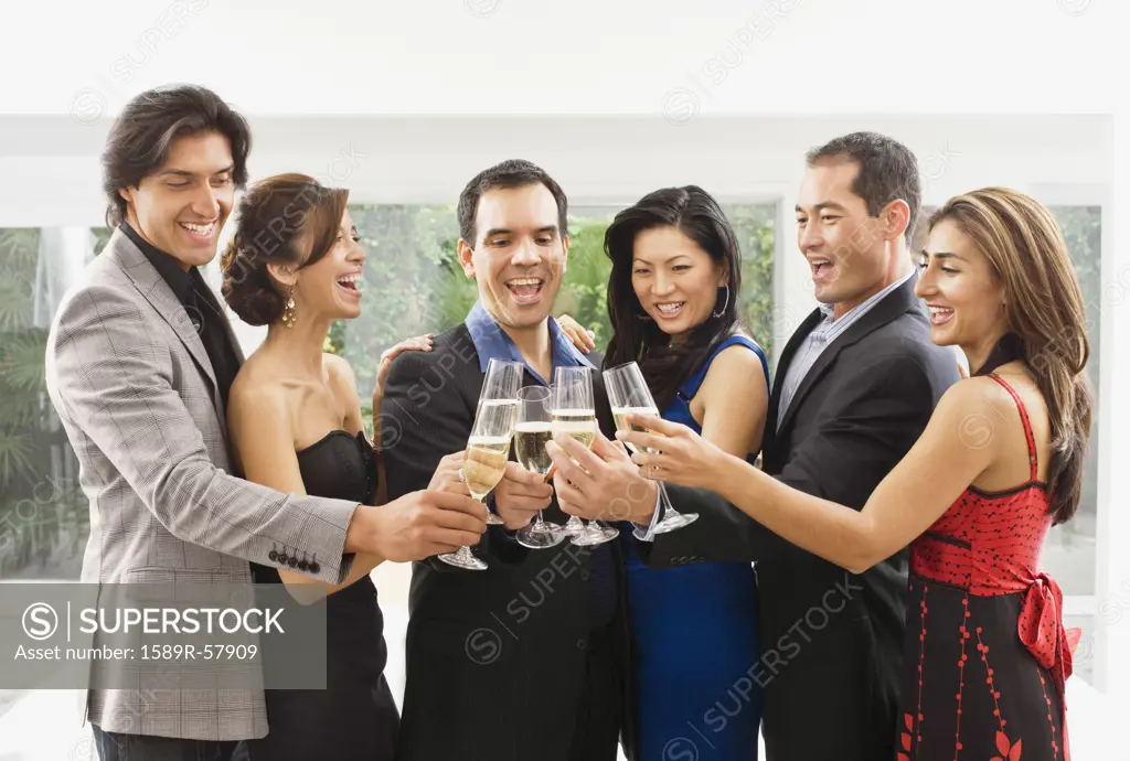 Multi-ethnic couples toasting with champagne