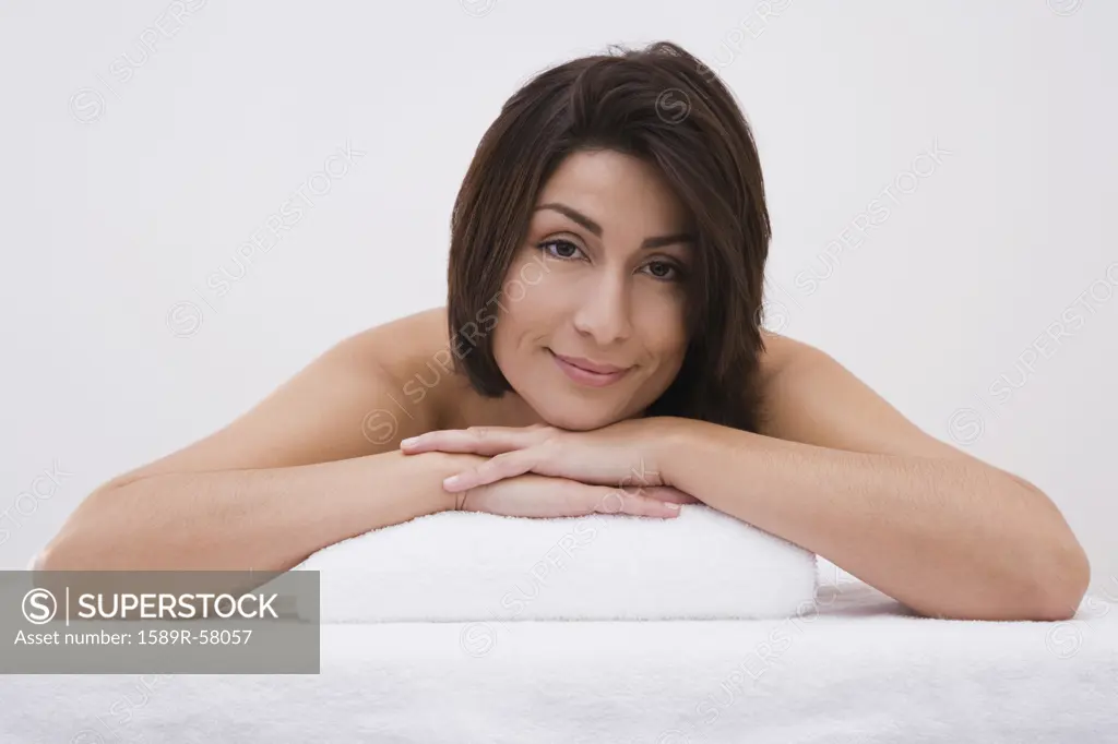 Hispanic woman laying on massage table